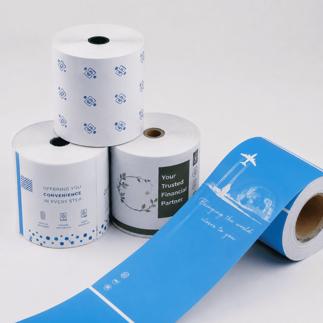 Custom printed thermal paper rolls with sample branding, icons, and promotional artwork