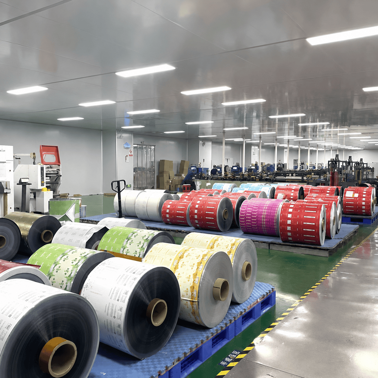Printed rollstock film packaging rolls in production workshop
