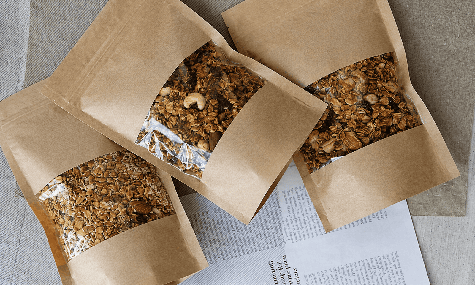 Moisture barrier packaging for dry food products with kraft paper window pouches
