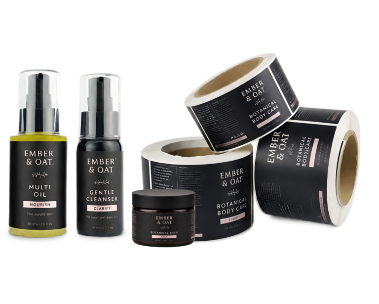 Printed cosmetic labels on skincare bottles beside self-adhesive label rolls