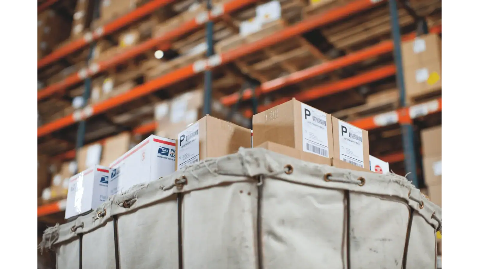 Warehouse worker scanning a barcode label on a carton for inventory management